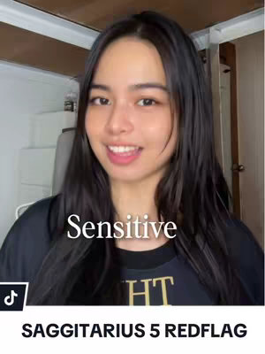 A woman with long black hair smiles directly at the camera. The text overlay 'Sensitive' is placed centrally over her image. At the bottom, the superimposed text 'SAGITTARIUS 5 REDFLAG' is featured. The background shows parts of a room.