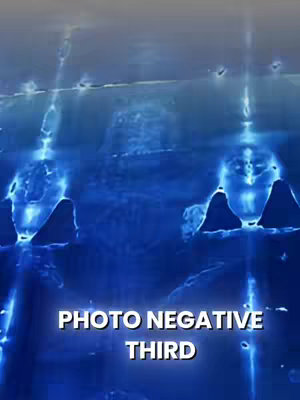The image is a dark blue, suggesting a nighttime or deep-sea theme. The composition features vertical lines and abstract shapes, with the text overlayed. The focus is on negative space and light, with the overall effect being somewhat abstract and mysterious.