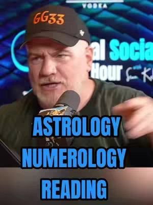 A man wearing a baseball cap with 'GG33' printed on it, facing the camera and speaking. The background is blurred but appears to be a studio setting. Below the man and overlayed on the image is the text 'ASTROLOGY', 'NUMEROLOGY','READING'.