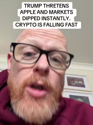 A man with red hair and a beard wearing glasses speaks to the camera. Above him, a text overlay displays headlines. The background is a blurry interior setting.