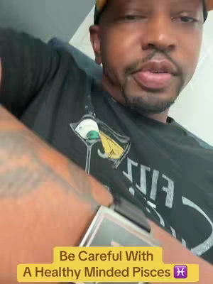 A man is filming himself with a low angle, with a gold brimmed yellow hat, black top, and a watch. The image has a text overlay in a yellow box.