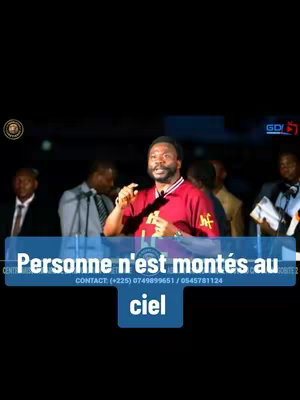 A man with a beard and a red shirt with the text "MF" on it speaks at an event. Text overlay on a blue rectangle reads "Personne n'est montés au ciel" and contact information. The background shows several people and a stage.