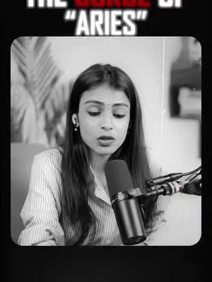 A black and white cover image featuring a woman in a striped shirt, speaking into a microphone. Text in a bold font at the top of the frame reads "THE CURSE OF ARISE". The background is blurred, suggesting an interior setting, and contains hints of plant life.