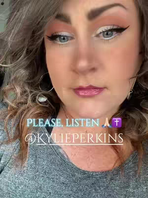 A close-up shot of a woman with curly, light-colored hair. She has makeup on, including eyeliner and lipstick. Text overlays include a call to listen and the creator's username, along with religious symbols.