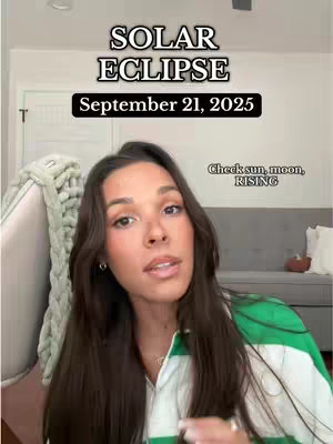 A woman looks directly at the camera in what appears to be a selfie video. The overlay text at the top of the frame indicates that the video’s topic is a solar eclipse and gives a date of September 21st, 2025. The woman has brown hair and is wearing a green and white top in what appears to be a casually decorated home.