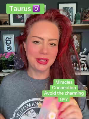 A woman with red hair and medium skin tone looks towards the viewer while holding up something pink; the top left corner shows a green banner with the text 'Taurus' along with the Taurus zodiac symbol. In the bottom right, a green rectangle displays a list with the words 'Miracles, Connection and Avoid the charming guy' in a white box.