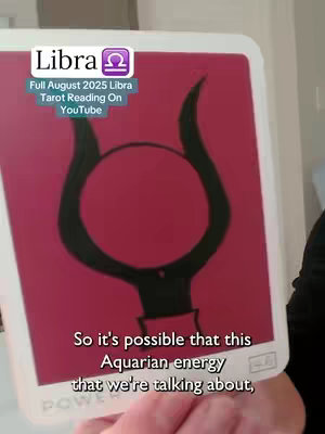 The cover image shows a tarot card held by a person on the right side of the frame. The card has a dark pink background with a black image in the center.  There is text overlaid in the upper left corner that says "Libra" with symbol, and other text in white, indicating the month and content of the video.