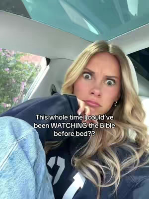 A young woman with blonde hair, wearing a black hoodie, sits inside a car. She has a surprised expression, with wide eyes and her mouth slightly open as she stares at the camera with her finger touching her cheek. The background shows the car's interior and a glimpse of a green, outdoor setting. Text is overlaid on the image.