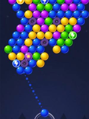 An illustration of a bubble shooter game with various colored bubbles clustered together in the upper portion of the frame. Below these, a blue bubble is being shot from a grey shooter. The background is a dark blue gradient with a few small white stars.