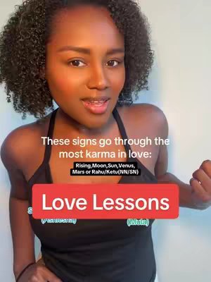 A woman with curly dark hair is centered in the shot, looking directly at the camera and speaking. The background appears to be a light space. Text overlays on the image read "These signs go through the most karma in love: Rising, Moon, Sun, Venus, Mars or Rahu/Ketu(NN/SN)" and, in a red box that covers the bottom of the image, "Love Lessons". The woman wears a black halter top. She has some pink blush on her cheeks.