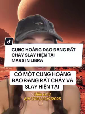 A woman in a black cap is centered in the image, set against a backdrop of a red planet and celestial objects. Two text boxes overlay the image. The top text box, in white, contains the phrases 'CUNG HOÀNG ĐẠO ĐANG RẤT', 'CHÁY SLAY HIỆN TẠI', and 'MARS IN LIBRA'. The second white text box beneath, includes 'CÓ MỘT CUNG HOÀNG', 'ĐẠO ĐANG RẤT CHÁY VÀ', and 'SLAY HIỆN TẠI', followed by 'Diễn ra từ' and a date range.