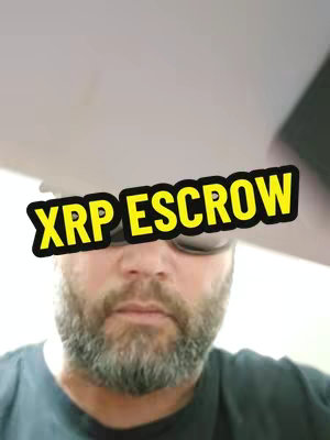A man with a beard wearing sunglasses is shown in a selfie-style shot. The background is a blurry ceiling. A yellow and black text overlay stating "XRP ESCROW" is placed prominently in the image.