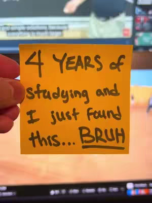 An image of a yellow sticky note held in a hand. The note has handwritten text that reads: "4 YEARS of studying and I just found this... BRUH". The background is blurred, showing a computer screen.