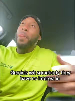 A man with a black cap and a neon green top is sitting inside a car. He's glancing upwards with his tongue out, suggesting a playful or sarcastic expression. Text on the image reads: 'Geminis wit somebody they have no interest in'.