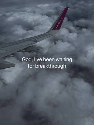 An aerial view shows a plane wing cutting through a sea of clouds. The wing is silver and extends towards the right, with the end of the wing featuring the purple tail of the WizzAir airline with its logo. Below the wing, dense, textured clouds fill the frame, creating a dramatic, overcast sky. White text is superimposed on this background.