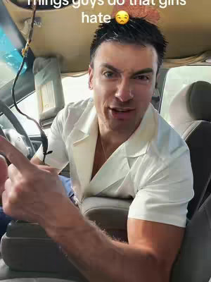 A man inside a car, pointing and speaking to the camera. Text overlay at the top.