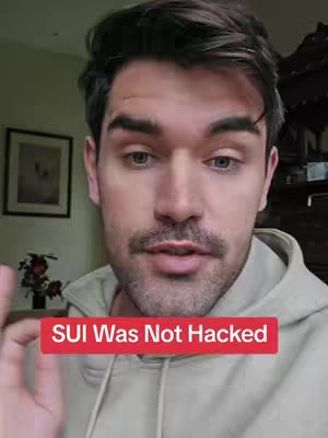 A man with a beard and mustache wearing a hooded sweatshirt is speaking towards the camera while a red banner labeled "SUI Was Not Hacked" overlays the bottom of the image.