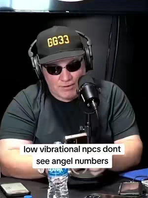 A man with sunglasses and a GG33 baseball cap sits in front of a microphone, with text on the image overlaying the bottom part of the image.