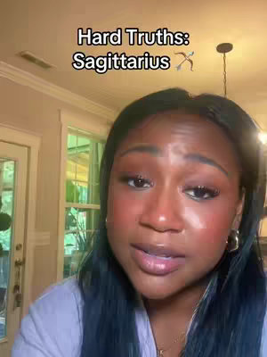 The cover image features a close-up of a woman with dark hair, looking slightly towards the side. The background is a blurred indoor setting with a warm color palette. Overlaid text reads 'Hard Truths: Sagittarius'.