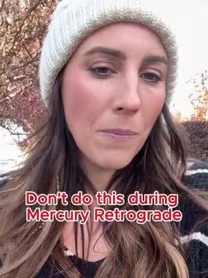 A woman with long brown hair wearing a white beanie is looking at the camera with a slightly concerned expression. Text overlays are displayed in a rectangular-shaped format at the bottom of the frame.