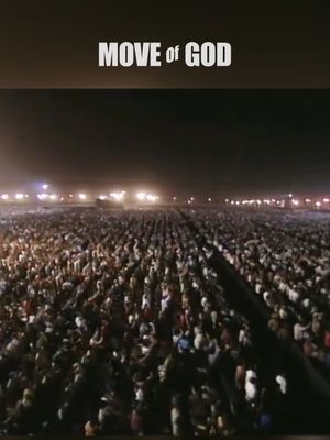 A wide, nighttime shot of a large crowd gathered in an open space, likely an outdoor event. The sky is dark, and sparse lights are visible in the distance, suggesting a large venue or field. The foreground is packed with people, their faces mostly indistinguishable due to the distance and low lighting, creating a sense of a large gathering. The text overlay at the top reads 'MOVE of GOD' in a bold, white font.