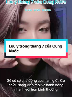 A selfie taken from a medium angle, featuring a person with light skin, reddish hair, and visible makeup, presented in front of a lightly blurred bluish background. The person is looking directly at the camera with a neutral expression. Text overlays are present, including the title \"Lưu ý tháng 7 của Cung Nước\" (Notes for July of the Water Zodiac) and other textual details. The image has a well-lit and clear quality with a focus on the person's face.