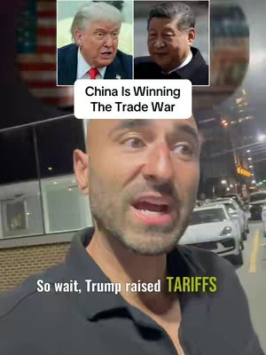 The cover image shows a man in a black shirt looking at the camera with an open mouth, framed against a backdrop of an urban street at night. Above him, in the upper portion, are two framed pictures: one of Donald Trump on the left and Xi Jinping on the right. A white banner with the text "China Is Winning The Trade War" is placed above the man. Below the man, overlaid on the image, are the words "So wait, Trump raised TARIFFS."