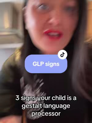 A selfie-style video cover featuring a woman speaking to the camera. There are two text overlays: a rounded rectangle with “GLP signs” and the title “3 signs your child is a gestalt language processor”. The woman is centered with a blurred background showing an interior setting.