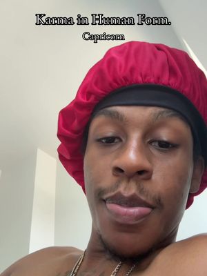A selfie of a man with a red cap that covers his hair with text that reads: "Karma in Human Form.  Capricorn"