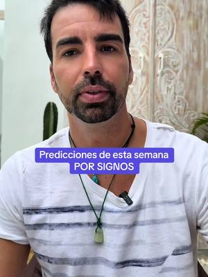 A medium shot of a man with dark hair and a beard, wearing a white t-shirt with horizontal gray stripes, and a necklace. He is looking directly at the camera. Overlayed on his chest is a purple rectangle containing white text.