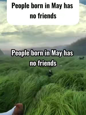 A field of green grass with a blurry backdrop of trees and sky; overlaid are two text boxes with matching text.
