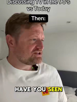 A man in a white t-shirt is speaking, with overlaid text. The background is a bedroom with a bed visible. The man has reddish hair and a beard. Text overlays at the top say "Discussing TV in the 90's vs Today" and "Then:" and at the bottom there is the text "HAVE YOU SEEN".