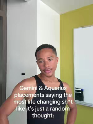 A frontal shot of a light-skinned man in a black tank top, positioned against a backdrop of white and yellow walls. He has short, dark hair and a slight smile. The overlay text is centered at the lower third of the image, written in white font.