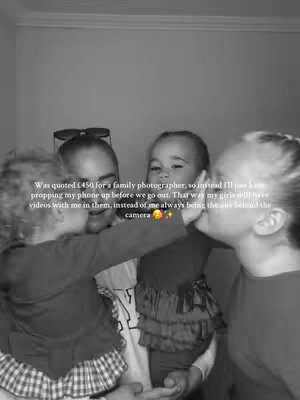 A grayscale image shows a woman and her two young daughters. The woman is in the center, with one daughter kissing her cheek and the other reaching towards her. The image is close-up, with the woman's face and upper bodies of the children visible. Text overlays the image.