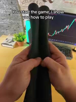 A first-person perspective shows hands holding two black microphones in front of a desk with a computer screen in the background displaying a trading chart, the hand is holding the microphone, with the additional text overlaying the image.