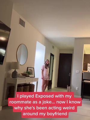 An interior shot of an apartment hallway. A woman in pajamas is standing and looking at the camera. The doorway is to the right, there's a mirror on the wall and a table with decor on the left. The background is a soft, neutral tone. The text overlay is in a red rectangle at the bottom of the image.