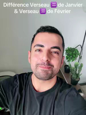 A selfie-style shot features a man with dark hair and a slight smile, set against a neutral background with a hint of a plant and a small cactus on the right. Text in the top left announces 'Différence Verseau de Janvier & Verseau de Février'.