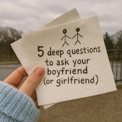 A hand holding two pieces of paper, stacked, with blurred background of trees and sky. The paper is textured and slightly yellowed, with text written in dark ink: '5 deep questions to ask your boyfriend (or girlfriend)'. Above the text is a simple drawing of two stick figures holding hands.