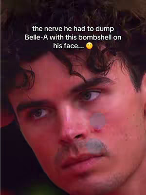 The image is a close-up shot of a man's face with a light-skinned appearance and dark curly hair. The primary focus is on his face, framed with a shallow depth of field. There is a text overlay at the top, written in white font. His expression appears to be one of contemplation or slight concern. The lighting and color scheme of the image seem natural, with a red cast.