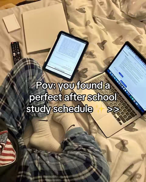 The cover image shows a person studying in bed. They are wearing blue plaid pajama pants and white socks with a Nike logo. A laptop and tablet with a stylus are placed on the bed with study materials nearby. The text overlay reads, "Pov: you found a perfect after school study schedule" with sparkles and a right-facing arrow symbol.