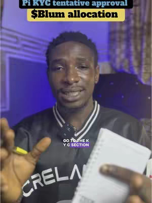 A man with short black hair is centered in the frame, giving an interview from a room. He is holding a notebook and pen in his hands. Text overlays highlight key information about Pi KYC and an allocation announcement. The background is a blurry mix of purple and blue hues.