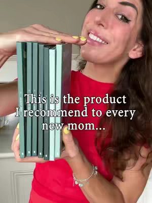 A woman is holding a stack of teal-colored books, with a part of her face visible in the upper right. She is smiling, with a red top  She is also wearing a silver bracelet. The text overlay on the image contains a promotional message.