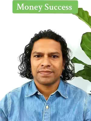 A man with dark curly hair smiles at the camera against a white background. A green bar with the text 'Money Success' appears above him. A large green plant is partially visible on the right side of the frame.