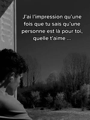 The black and white image shows a person from the back looking out of a window at a dark, tree-filled landscape. Text is overlaid on the image.