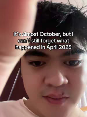 A selfie-style shot featuring a person with visible text overlay, framed from the chest up. The person has short, dark hair and appears to be of Asian descent. The person is positioned slightly off-center, with their features mostly in focus. They are looking down and to the side. The text overlay is centered above the person's head.