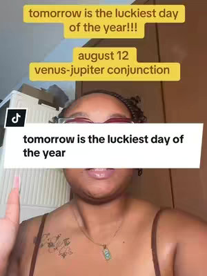 The cover image shows a woman's face and upper body. She is wearing a brown top and a necklace with a teal pendant. A tattoo of flowers is visible on her left shoulder. There are several text overlays: one in a bright yellow box saying 'tomorrow is the luckiest day of the year!!!,' another with 'august 12 venus-jupiter conjunction,' and another white box overlay with black text that states, 'tomorrow is the luckiest day of the year.'