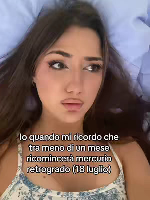 A close-up shot of a young woman lying down, looking upwards with a slightly concerned expression. The background is blurred, suggesting she is in bed or a similar relaxed setting. Text overlayed on the image reads in Italian.