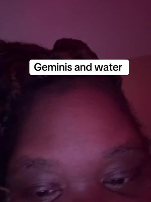 The cover image shows a close-up of the upper portion of a person's face, centered on the forehead and eyes. The background is a gradient of dark red and purple hues. A white rectangular text box with rounded corners sits just above the person's eyes, displaying the words "Geminis and water" in black text. The overall composition is simple and focuses on the person's face.