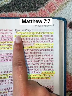 A hand pointing at a highlighted Bible verse, Matthew 7:7, with the text 'Matthew 7:7' in a white box at the top and additional text above the verse. The background is a soft, textured surface.