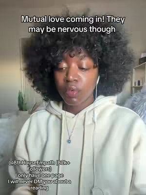 A woman with dark, curly hair and a light-colored hoodie is looking up at the camera. Text overlays state "Mutual love coming in! They may be nervous though" and a username with follower count below.